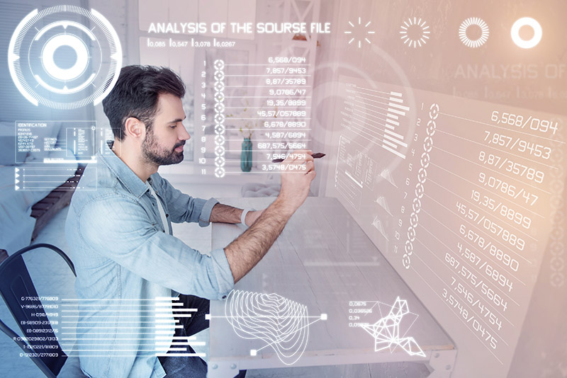 Drawing carefully. Attentive calm experienced designer holding a modern stylus while sitting alone and drawing